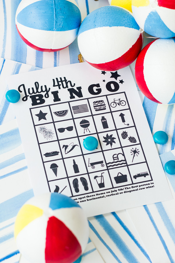 Free Printable July 4th Bingo PDF Free Printable July 4th Bingo page on a blue painted background with blue candies and beach balls.
