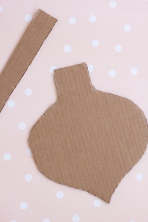 Cardboard shape on a pink surface