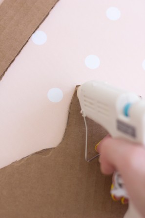 Someone gluing cardboard