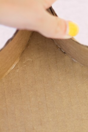 Someone making a cardboard craft