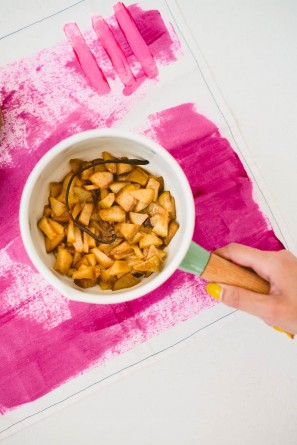 Someone holding a bowl with pears 