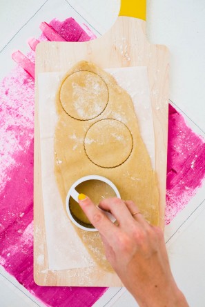 Someone cutting dough into circles 