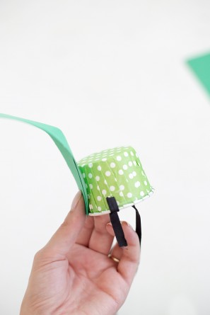 green leaf being glued on paper cup