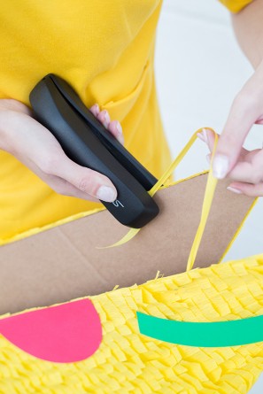 Someone stapling something on cardboard