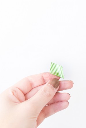 Someone holding green tape 
