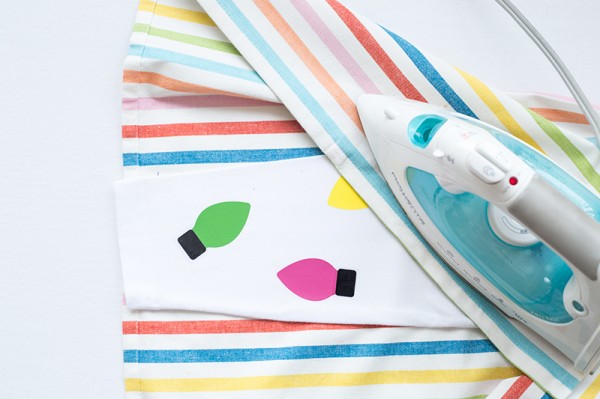 Someone ironing a rainbow fabric on leggings