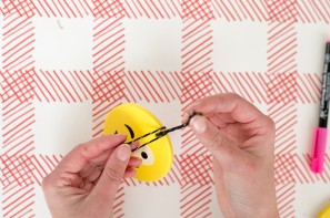 Someone making an emoji ornament