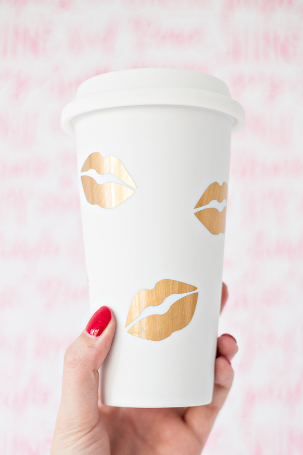 A paper cup with gold lip prints 