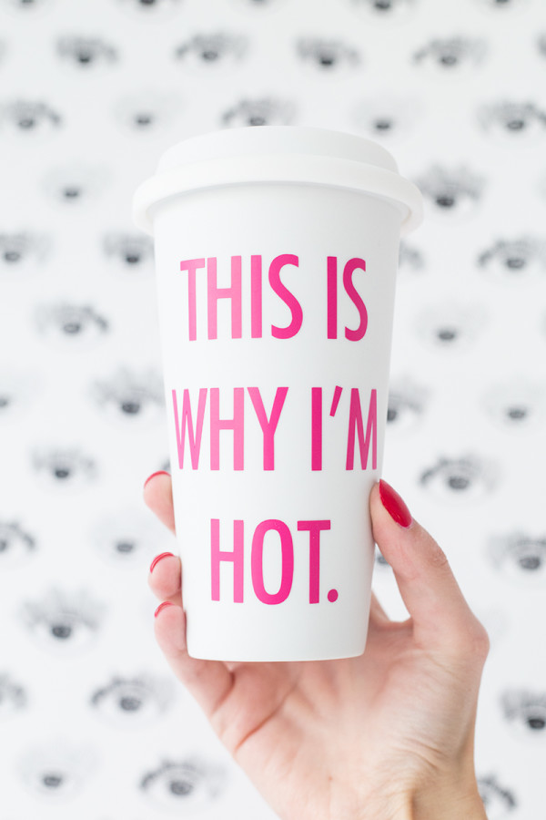 A white cup with pink words 