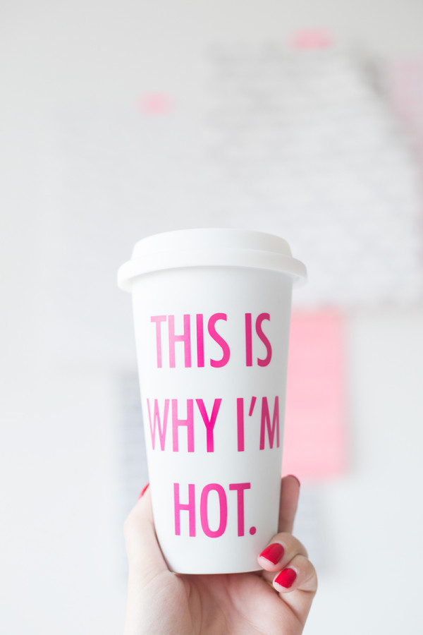 A paper mug with pink words