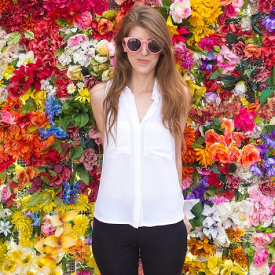 The Road to Studio DIY: My Background Story! A woman standing in front of flowers
