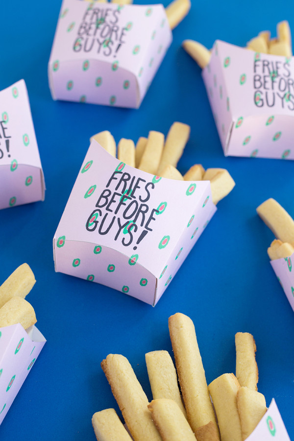 Fries in boxes that say \"fries before guys\"