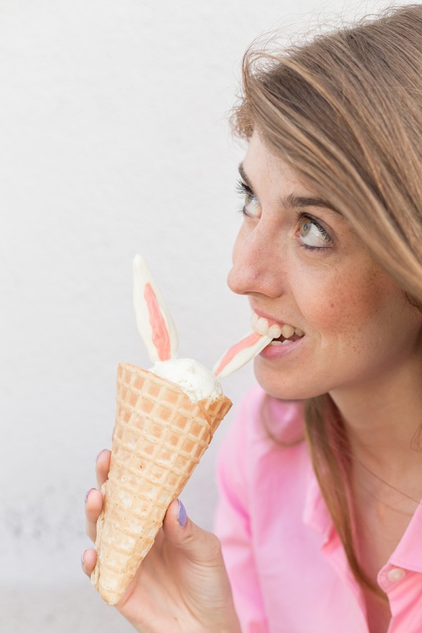 Someone biting bunny ear ice cream