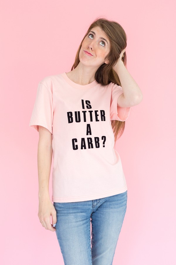 A pink shirt with black words on it