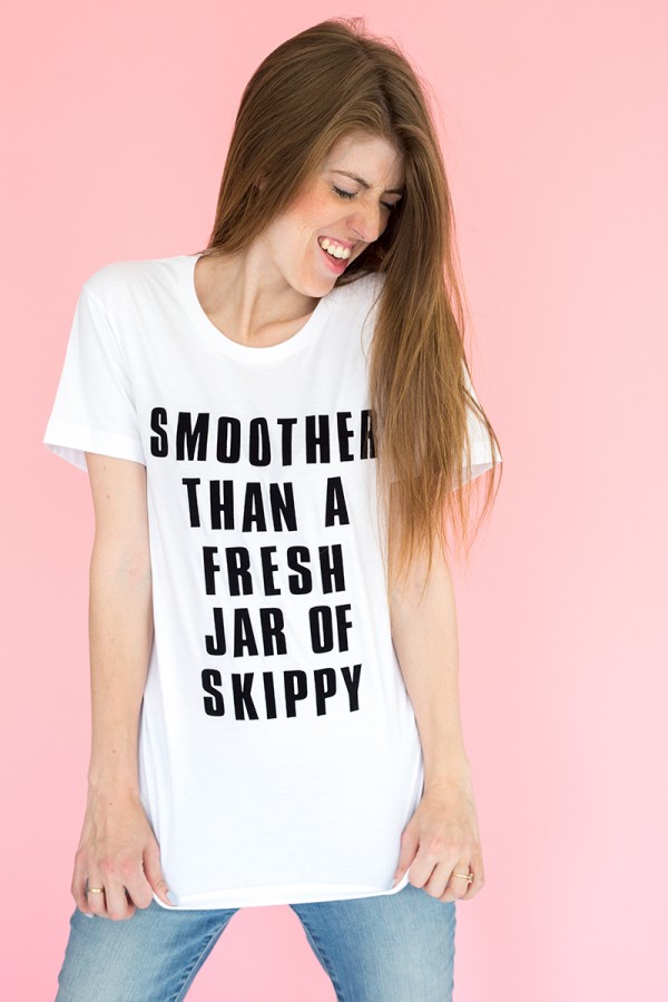 A woman in a white top with black words on it