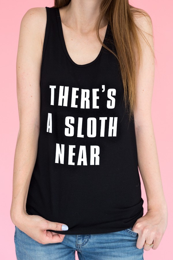 A woman in a black tank with white words on it