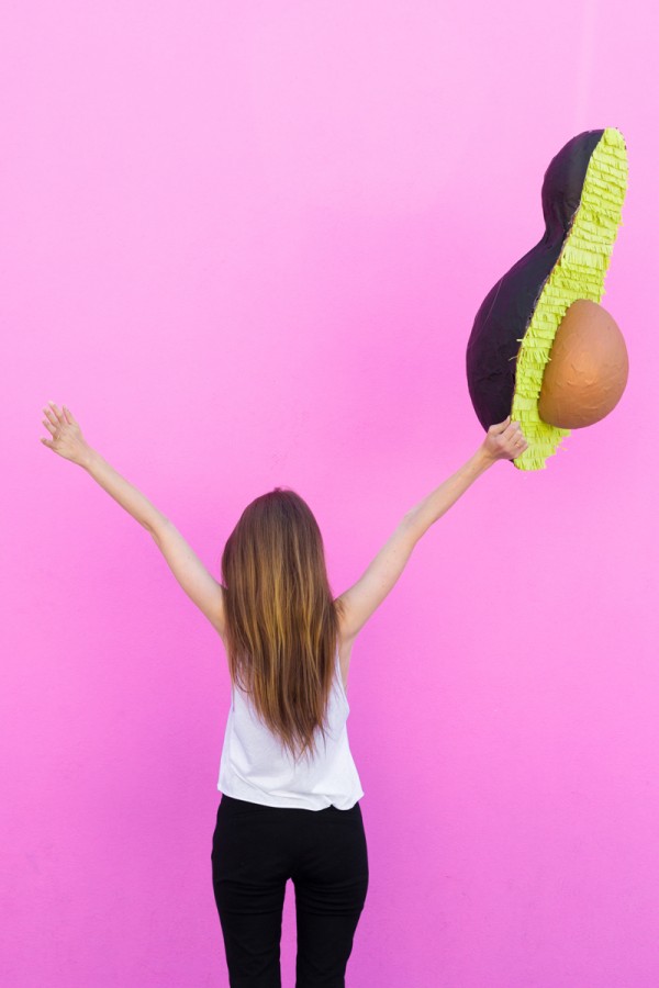 Someone holding an avocado pinata