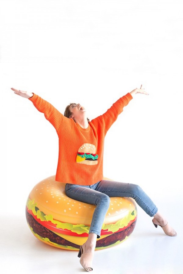 A woman sitting on a burger float
