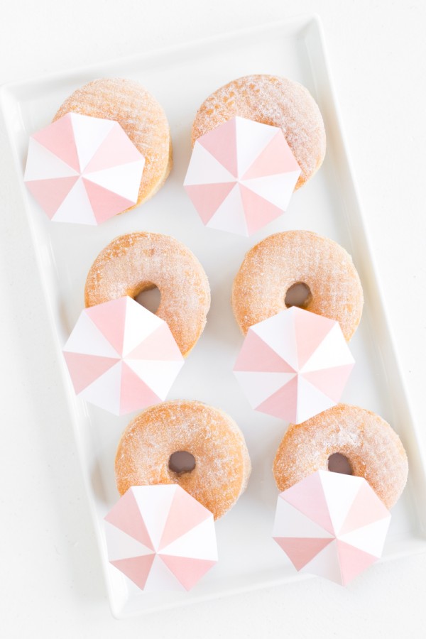 A box of donuts with umbrellas