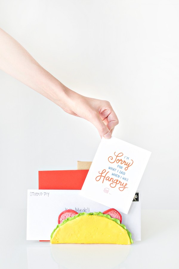 Someone putting cards in a taco letter holder