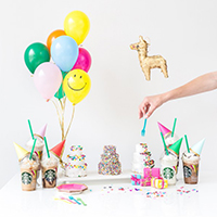 Party decorations with balloons, drinks, party hats, etc.