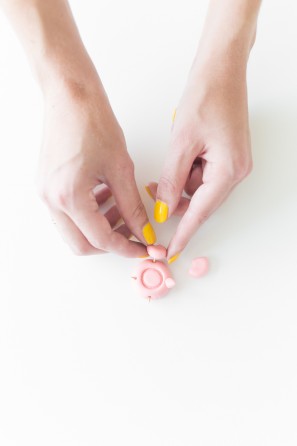 Someone putting clay together 