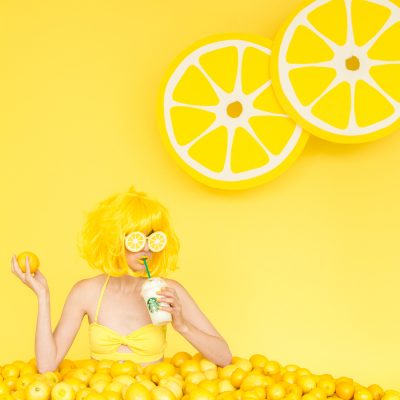 When Life Gives You Lemons: DIY Lemon Photo Booth A woman dressed as a lemon drinking a drink