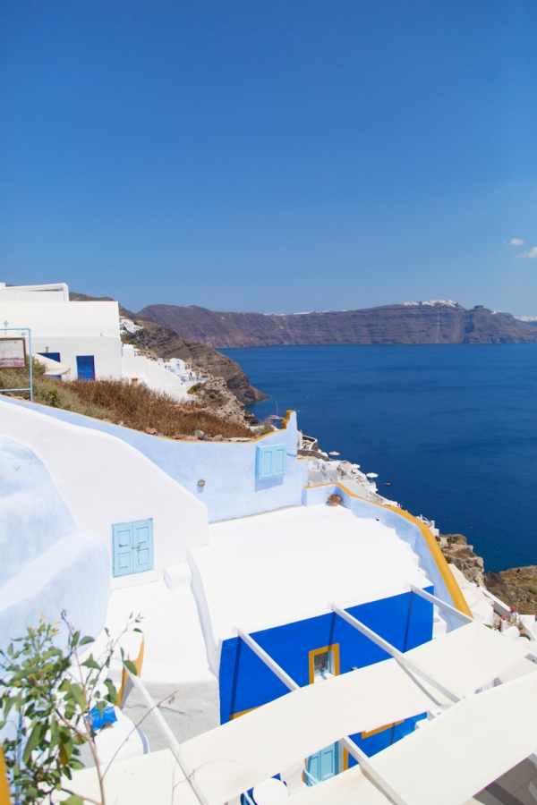 White building with blue windows on the coast