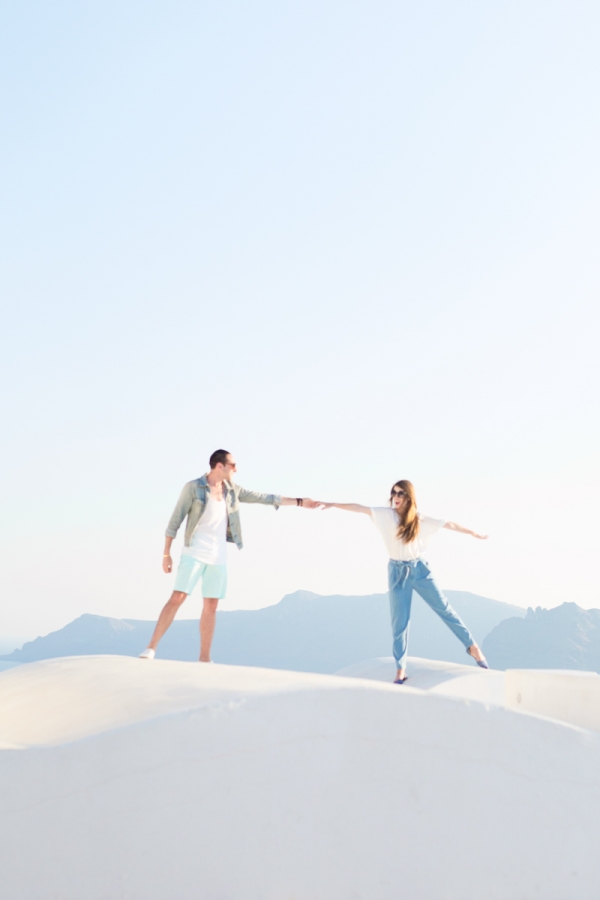 Two people holding hands on a white surface