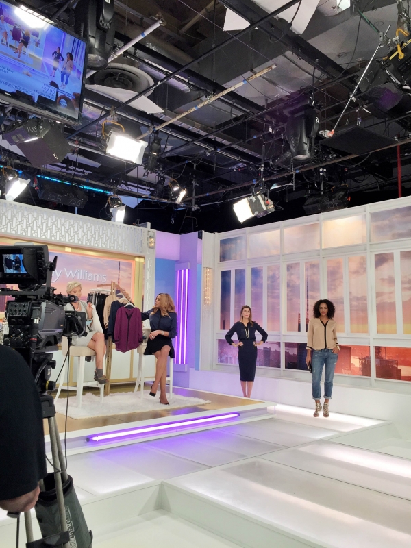 A group of people standing in a room being filmed