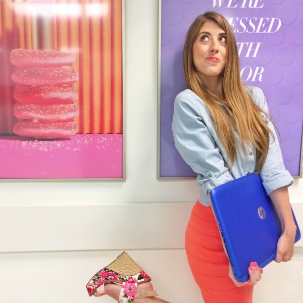 A woman standing in front of framed pictures