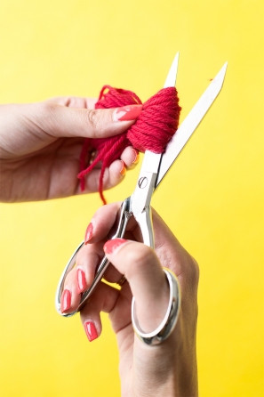Someone cutting red string