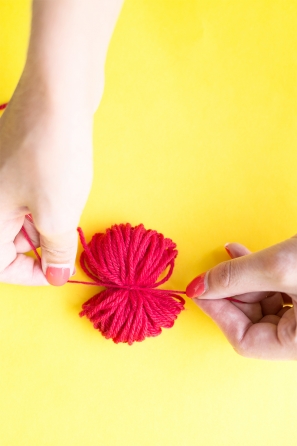 Someone wrapping red string