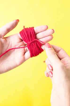Someone wrapping red string