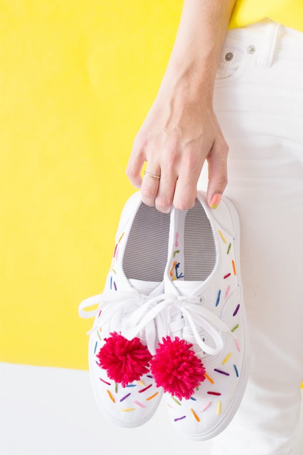 Someone holding white sneakers