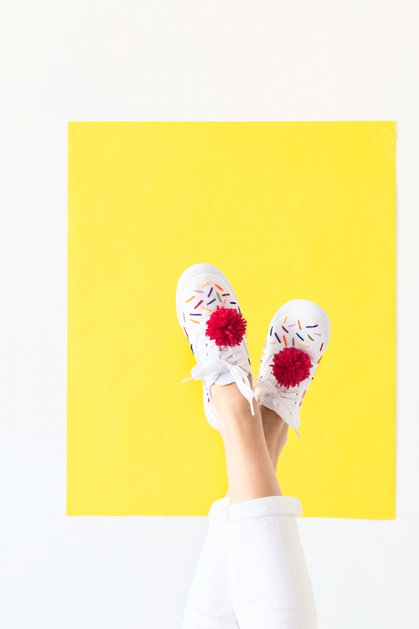 Sneakers with red pom poms
