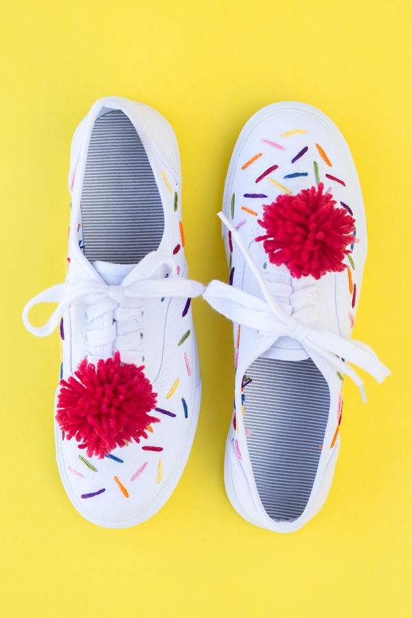 Sneakers with red pom poms