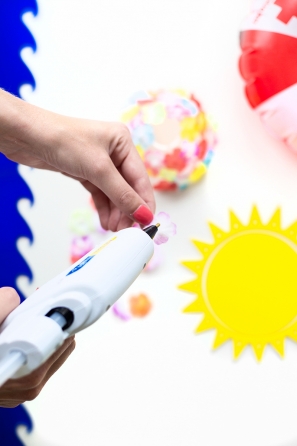 Someone holding a hot glue gun