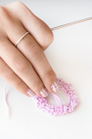 Someone sewing a pink shape