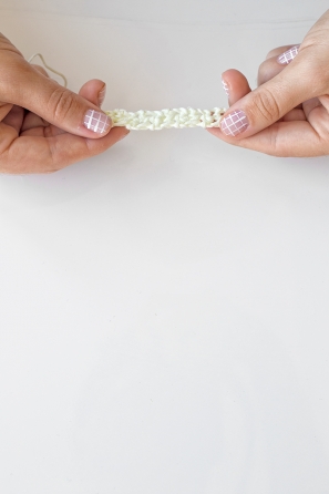 Someone holding a white knitted item