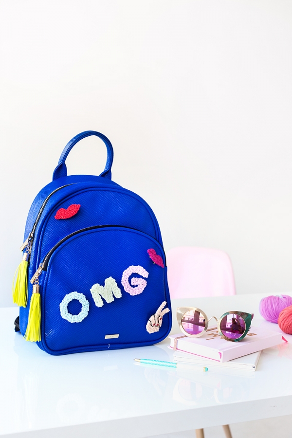 A blue backpack that says \"OMG\"