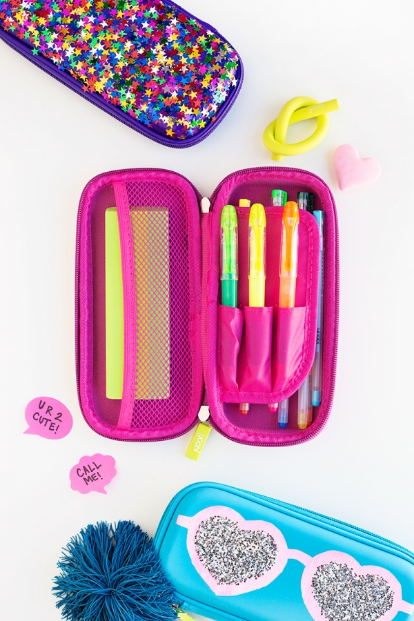 Pink pencil case with pens in it