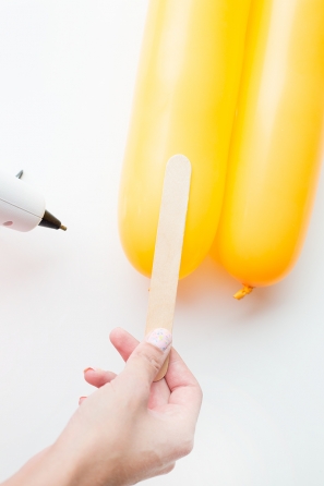 Wood stick and yellow balloon
