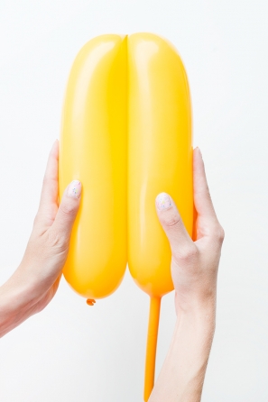 Someone holding a yellow balloon