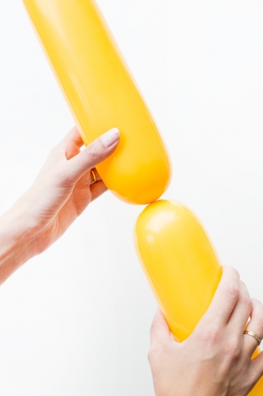 Someone holding a yellow balloon