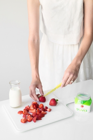 Someone cutting strawberries 