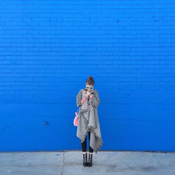 A woman in front of a blue wall