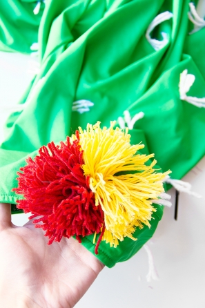 A green shirt with white strings and fake flowers