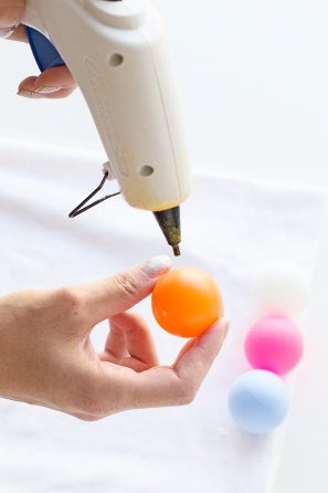 Someone gluing a ball