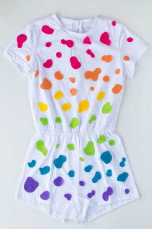 A white jumpsuit with colorful dots on it